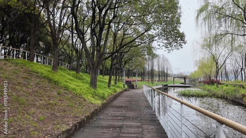 Shanghai World Expo Park, Shanghai: Pathway alongside waterway in urban park surrounded by trees and modern infrastructure.