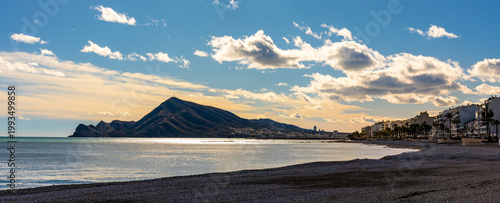Panoramic view of Serra Gelada mountain and Raco del Pallares rocks over port, touristic city center and Mediterranean Sea Costa Blanca Altea beach in Spain