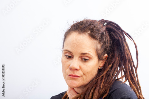 Quiet introspective woman looking down in reflective mood