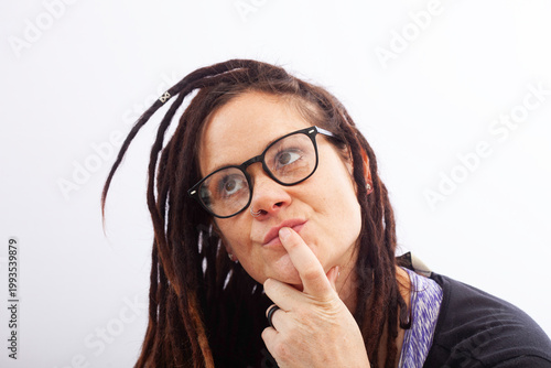 Thoughtful woman wearing glasses looking up in contemplation