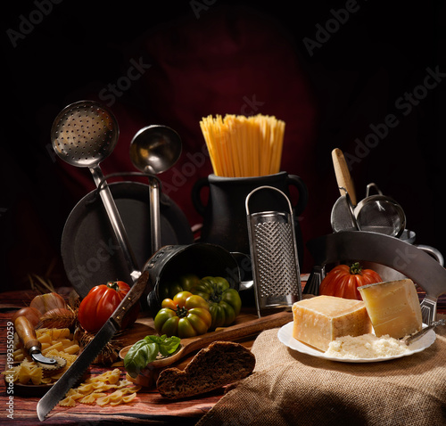 Tableau sur toile Still life, natura morta con pomodori su tavola imbandita con scenografia di vas