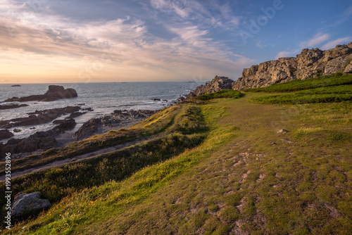 Scenic coastal landscape of Guernsey with lush greeney overlooking turquoise Atlantic ocean.