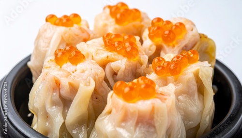 Tender pork and shrimp siu mai dumplings topped with bright orange roe, a savory Asian delicacy