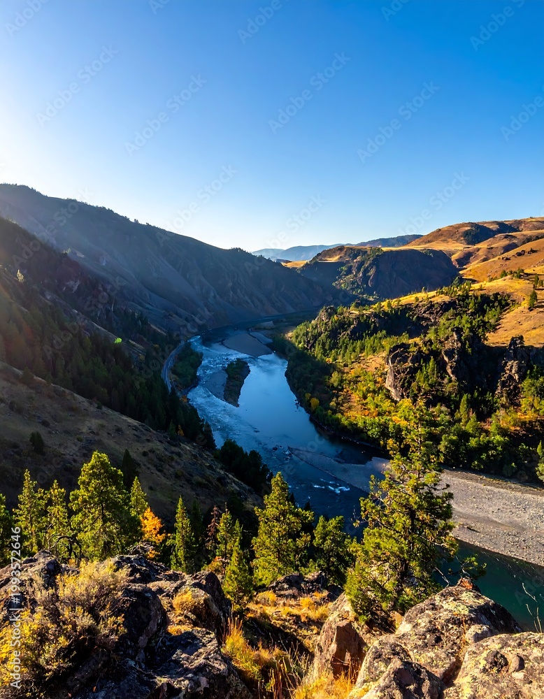Naklejka premium Serene River Winding Through Mountains.