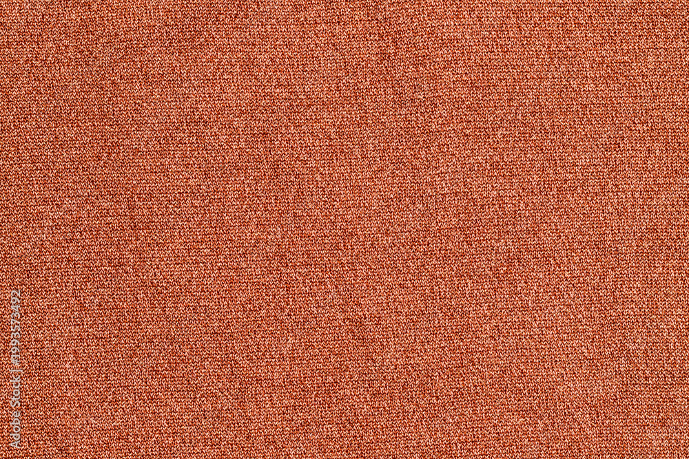 Fototapeta premium Fabric texture in orange color used for clothing or decoration in a bright setting