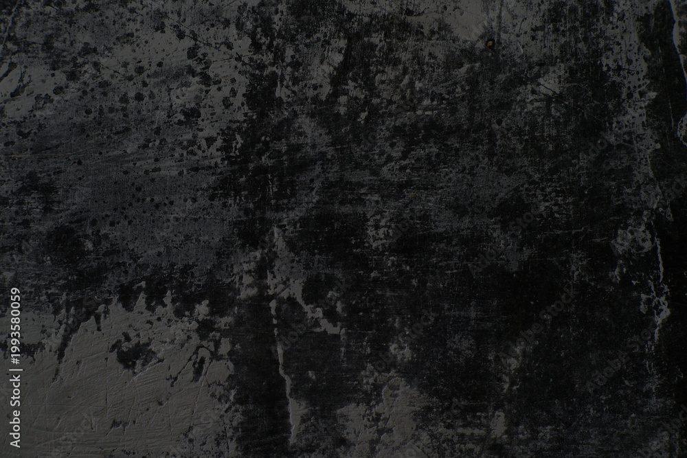 Fototapeta premium The texture of the old wall is rough and dark with faded paint.