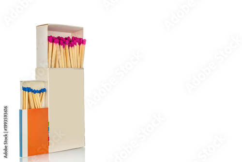 Wooden matches in paper boxes isolated on white background, close-up.