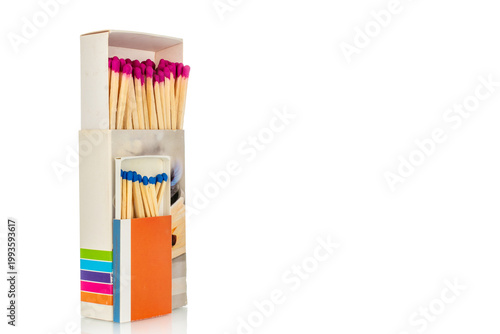 Wooden matches in paper boxes isolated on white background, close-up.