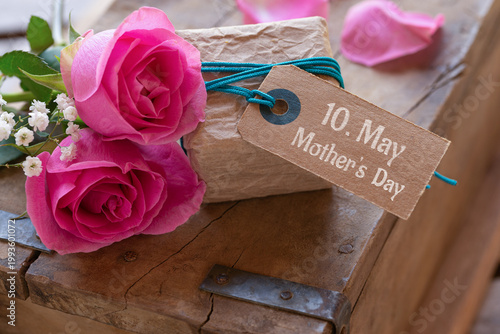 Mother's Day - Cute little gift package with pink roses and text 10. May Mother's Day on old wooden box