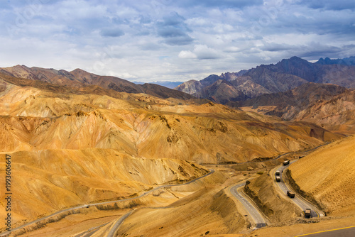 Indian Military trucks passing through Zigzag road, famously known as jilabi road at old route of Leh to Srinagar Highway, Ladakh, Jammu and Kashmir, India. Scenic and popular route through mountains.