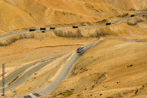 Indian Military trucks passing through Zigzag road, famously known as jilabi road at old route of Leh to Srinagar Highway, Ladakh, Jammu and Kashmir, India. Scenic and popular route through mountains.