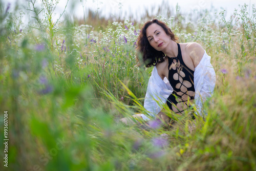 Woman in Black Swimsuit Relaxing in Wildflower Meadow