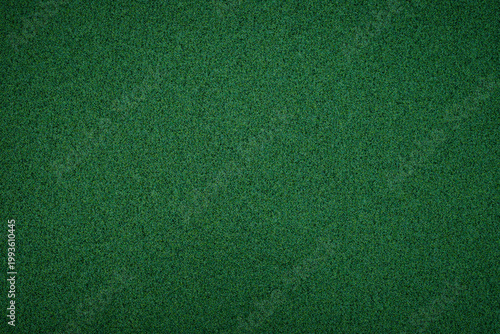 Bright green carpet covering a smooth surface in a room during daytime showing clear and clean texture