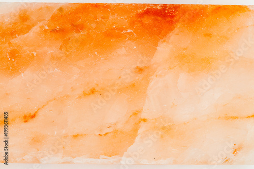 Bild auf Leinwand Orange salt block used for cooking on grill or in oven in kitchen setting