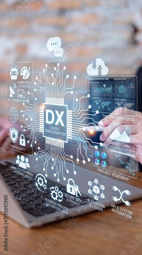 A person using a laptop with digital transformation graphics overlayed on the screen