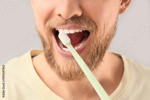 Young bearded man brushing ...