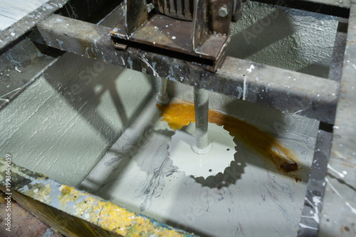 Industrial paint mixer machine in a workshop. Chemical processing and manufacturing of coating materials using heavy duty machinery