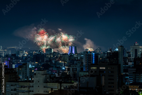 Fireworks over buildings at night