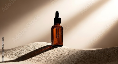 Brown glass dropper bottle on sand.