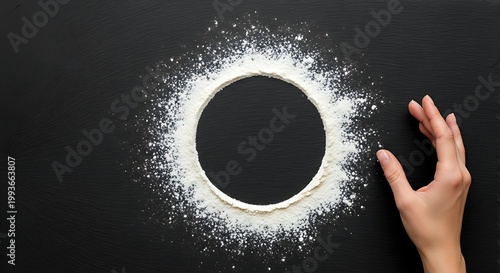 Artistic Flour Circle with Hand on Black Background for Design.