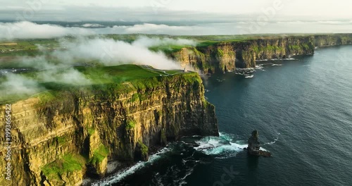 Cliffs of Moher and O Brien Tower at Sunrise, Aerial Drone Pullback Over Atlantic Coast, County Clare Ireland