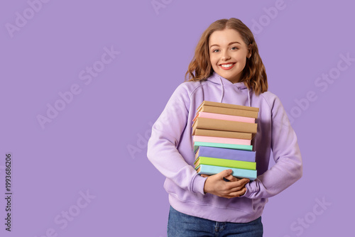 Young woman with stack of b...