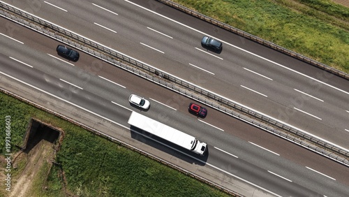 Schilderij op canvas Fast cars and heavy traffic in motion drive along the urban highway lanes of a b