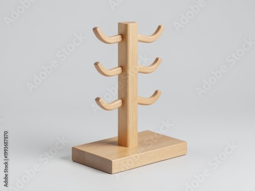 Minimalist wooden tabletop accessory rack with six curved hooks in light oak, isolated on a light grey studio background, premium product design concept.

