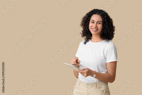 Smiling young woman using t...