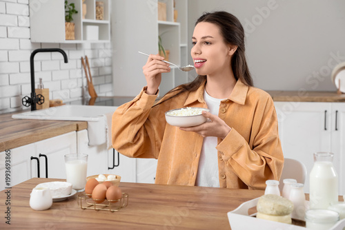 Young woman eating cottage ...