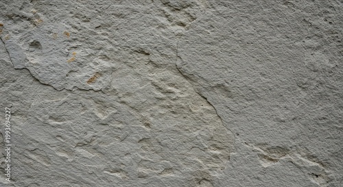 Detailed view of a rough, weathered old gray stone wall surface texture, perfect for backgrounds or architectural design elements, facade, stone, aging