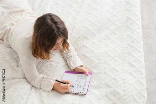Young woman writing 2026 go...