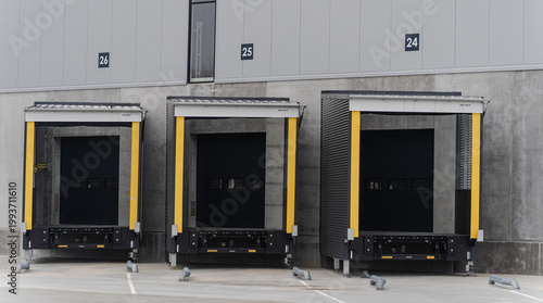 Fotografia Warehouse loading docks with protective gates in industrial area.