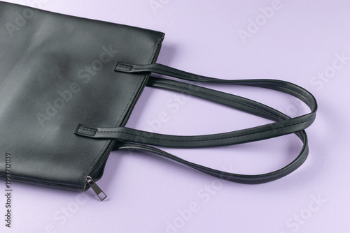 Elegant Black Leather Tote Bag on Pastel Purple Background