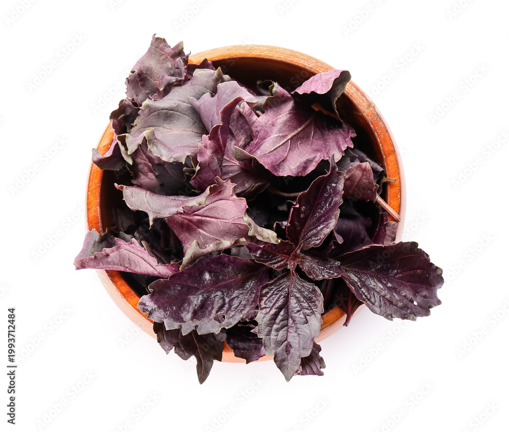 Fototapeta premium Wooden bowl with fresh purple basil leaves on white background