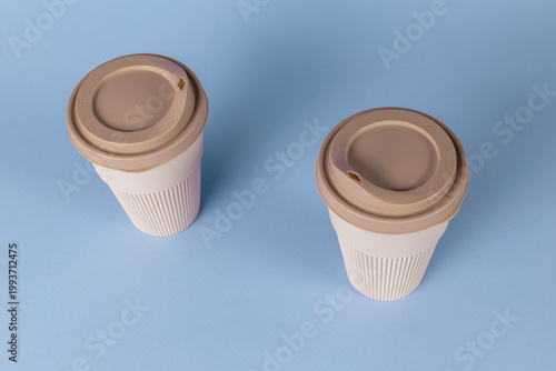 Reusable Coffee Cups on Blue Background: Sustainable Lifestyle Trend