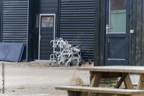 Metal structures near building entrance in courtyard in urban environment.