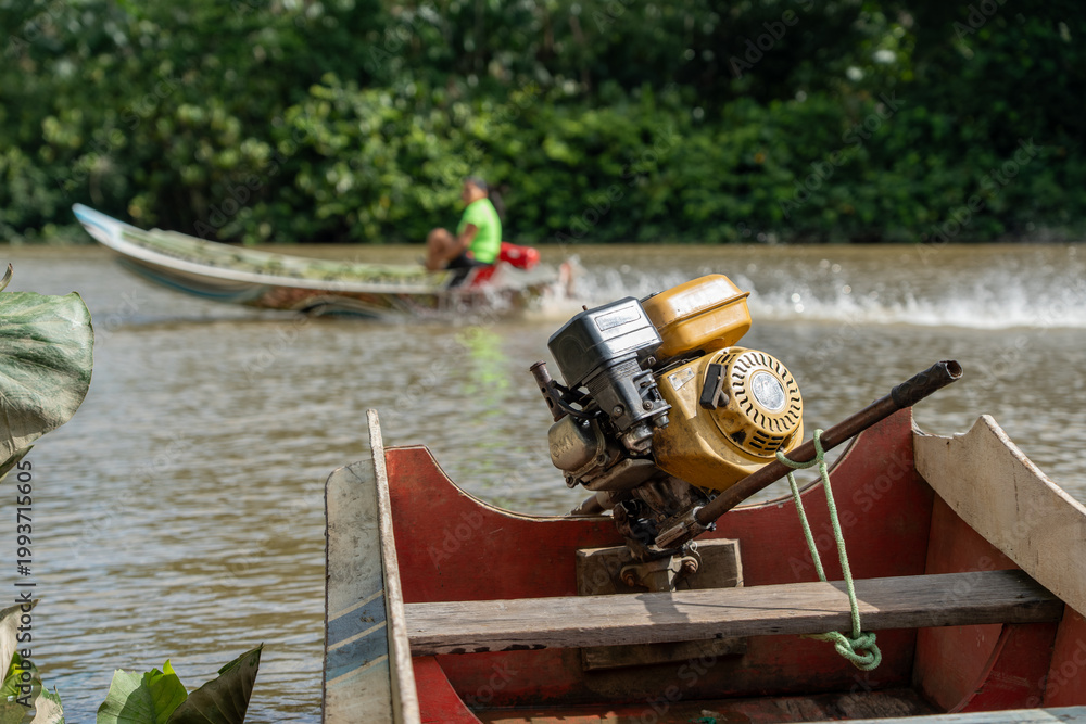 Obraz premium mazon river canoe with long-tail motor on a sunny tropical day
