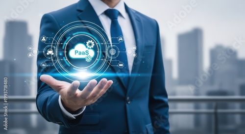 Businessman holding a glowing cloud paas icon with digital network connections