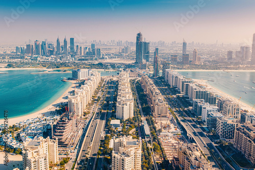 Dubai cityscape featuring the iconic Palm Jumeirah island, luxury resorts, and urban skyline with Persian Gulf waters