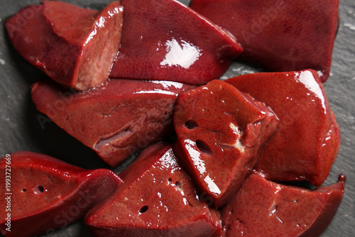 Raw liver on black background