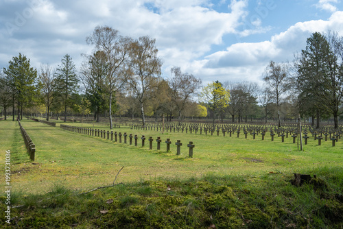 Memorial Site WOII With Rows of Grave Markers Under a Cloudy Sky in a Serene Landscape Setting