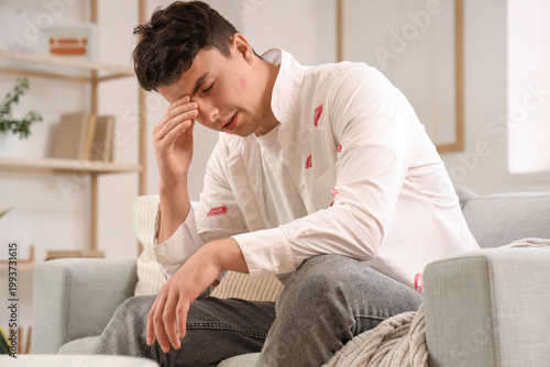 Valokuva Sad man with kiss marks on his shirt at home