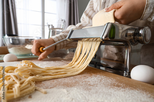 Young woman making pasta wi...