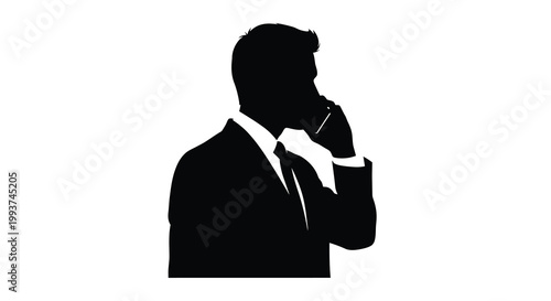 Silhouette of a man in a suit thoughtfully holding a pen to his chin