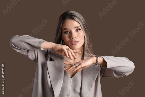 Elegant young woman in beig...