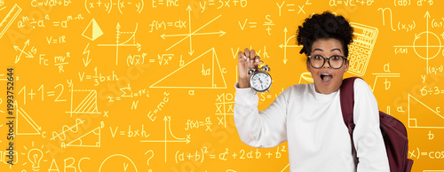 Photos A student stands against a bright yellow background filled with math symbols and equations