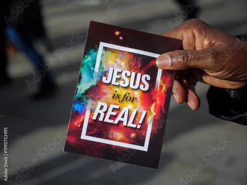 Religious Christian proselytiser handing out leaflets declaring that Jesus is for real
