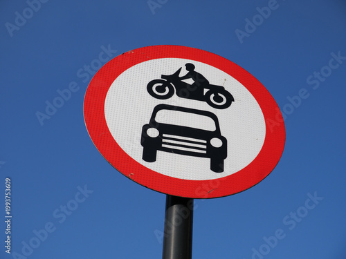 No motor vehicles allowed road traffic red circle sign of motorbike above car, UK