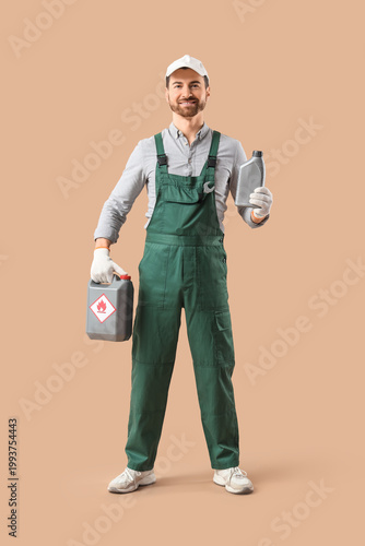 Принти на полотні Male mechanic with canisters on beige background